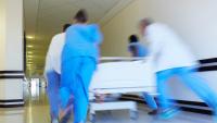 Hospital staff rushing a patient off to theatre in urgency